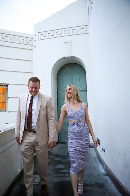 Groom carrying bride on stone steps